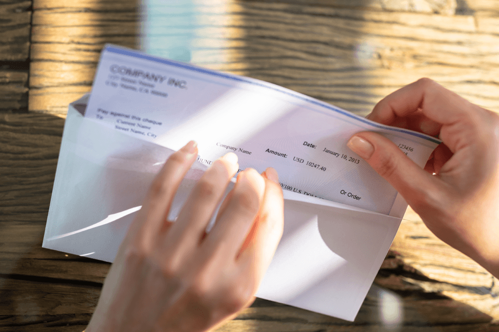 Paycheck Putting paycheck in envelope